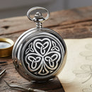 Silver pocket watch with a Celtic knot design on a white background