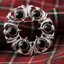 Dancers Thistle Plaid Brooch showcasing its intricate thistle and plaid design with a striking colored stone, crafted from high-quality pewter.
