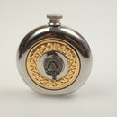 MacNeil Clan Crest Pewter Sporran Flask displayed outdoors, perfect for outdoor adventures and family gatherings.
