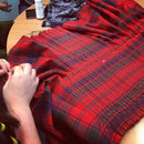 A folded view of the Robertson Red Modern Heavyweight Hand Stitched Kilt, emphasizing the quality materials and design.