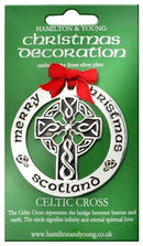 Silver Plated Christmas Decoration Celtic Cross hanging on a Christmas tree, showcasing its intricate design and shiny finish, perfect for festive decor.